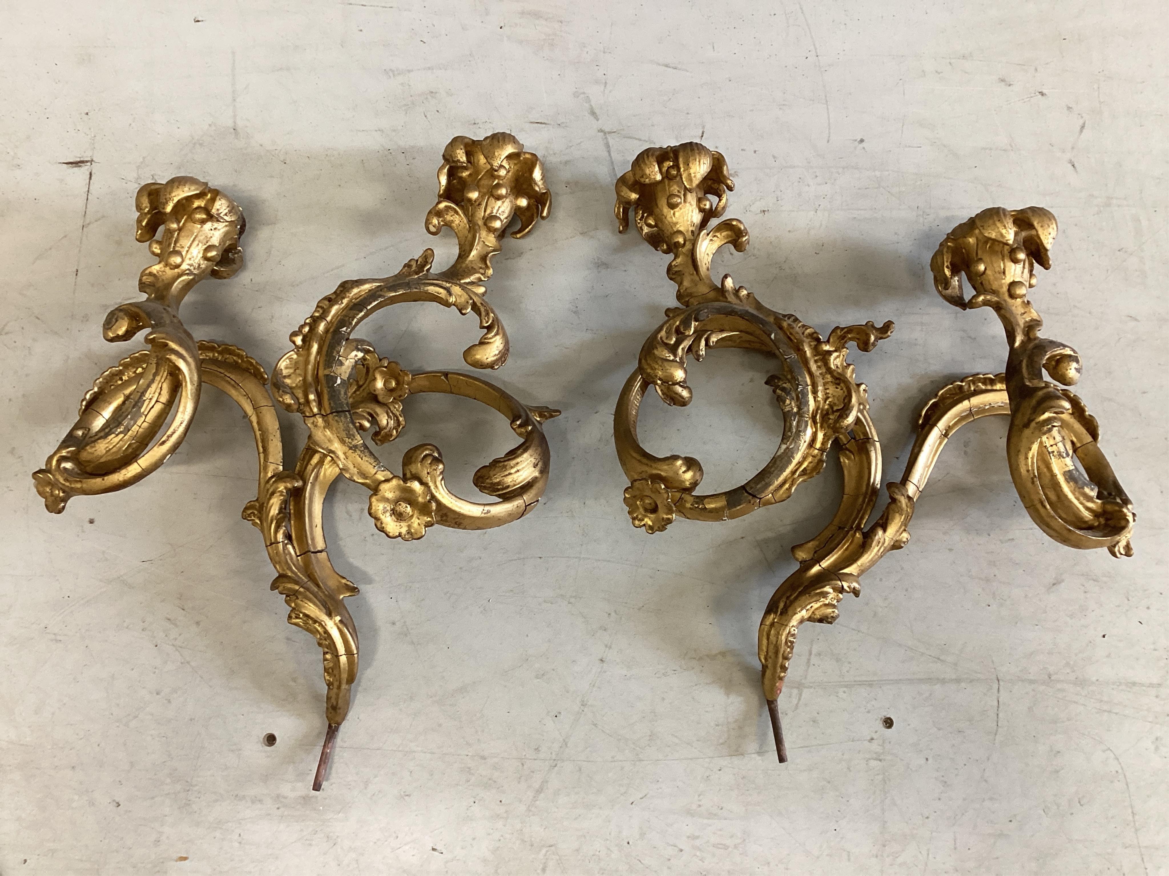 A pair of Victorian giltwood and composition twin branch wall lights (from a girandole), height 42cm. Condition - fair